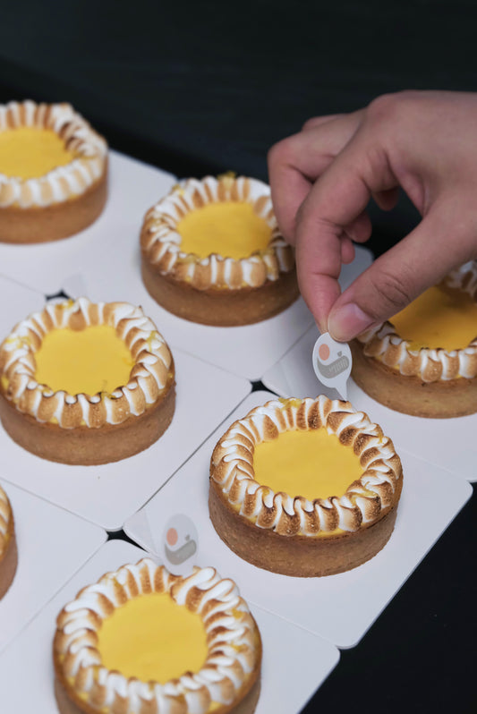 A Lemon Meringue Tart with a crisp sablé tart shell, nutty almond frangipane, tangy lemon curd, and velvety Swiss meringue for a perfect balance of sweet, tangy, and nutty flavours